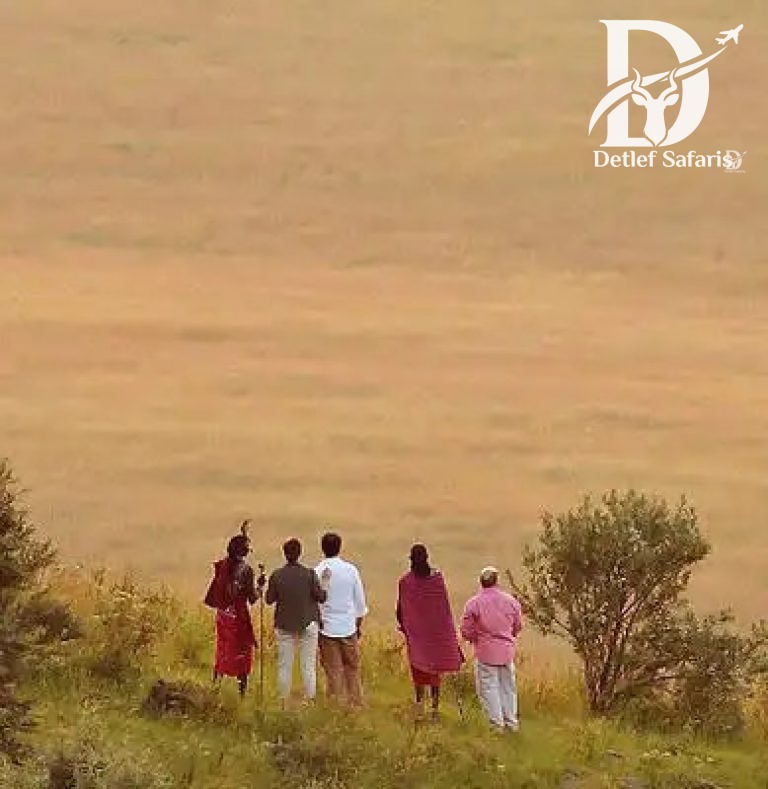 Guide and visitors overlooking the Maasai Mara escarpment, Kenya
