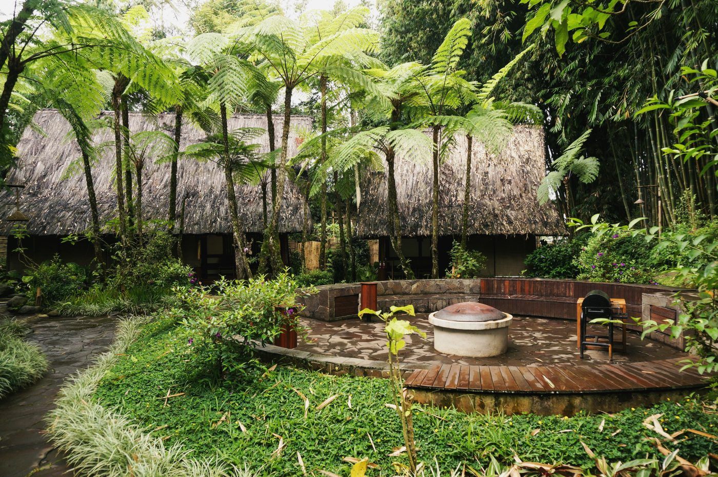 Five Volcanoes Boutique Hotel thatched cottages and fire pit, Volcanoes National Park, Rwanda