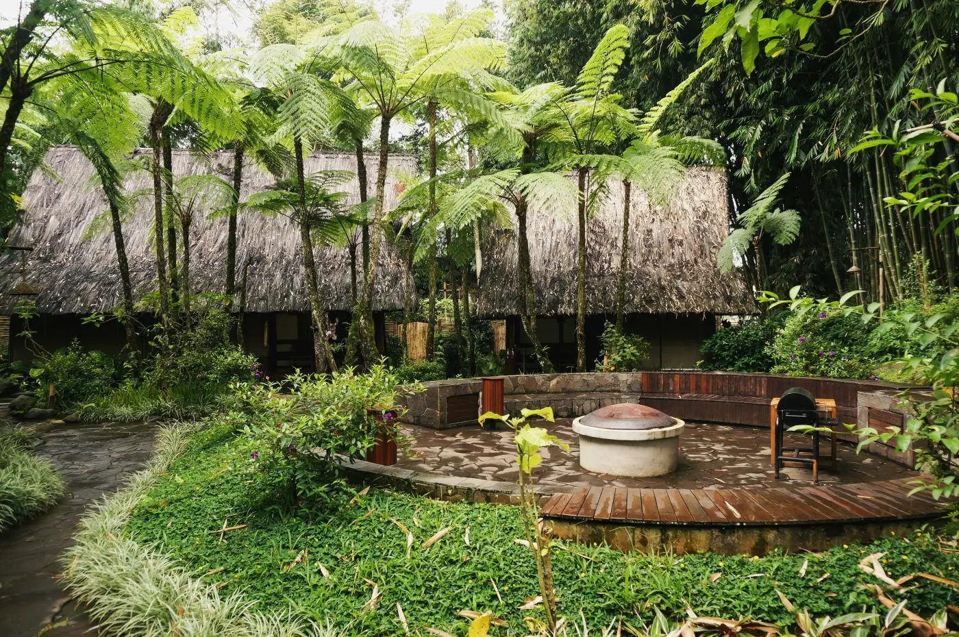 Five Volcanoes Boutique Hotel thatched cottages and fire pit, Volcanoes National Park, Rwanda